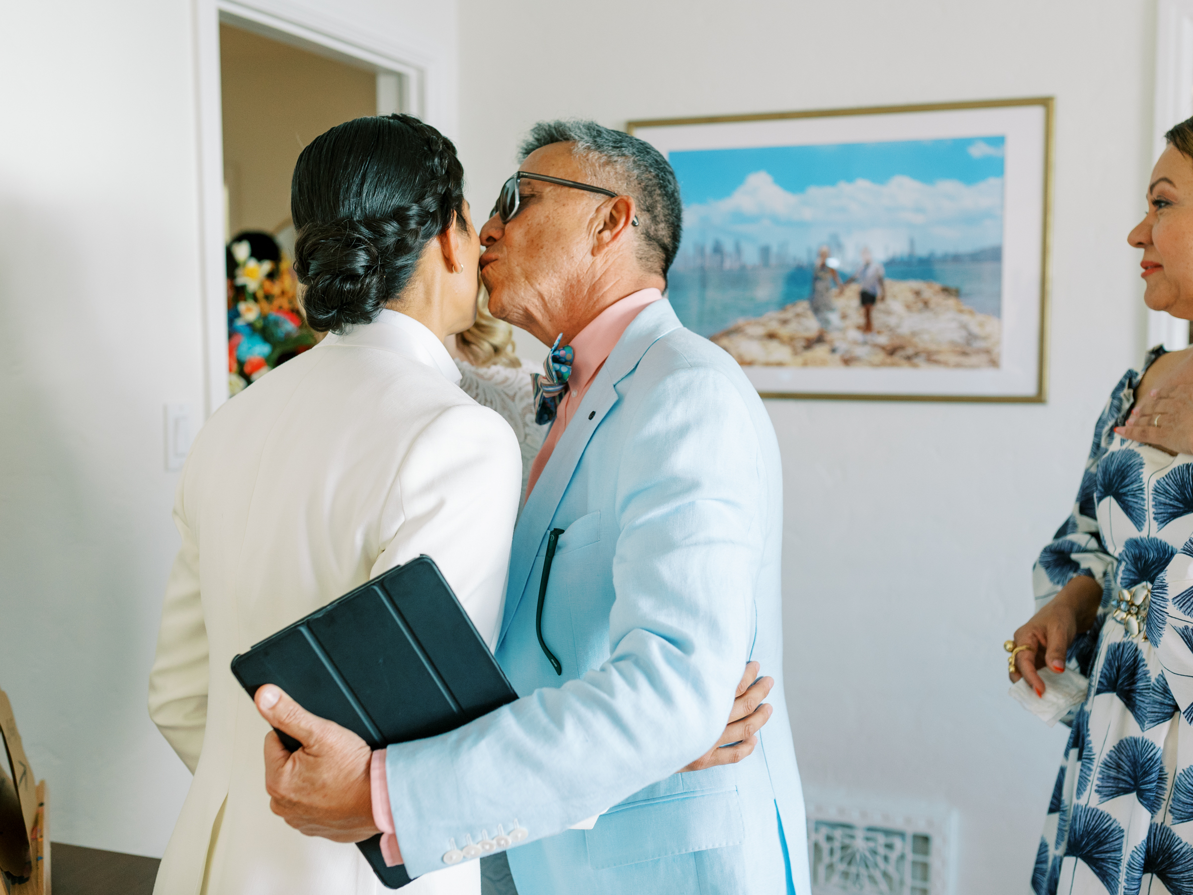 father of the bride kissing his daughter after officiating the ceremony