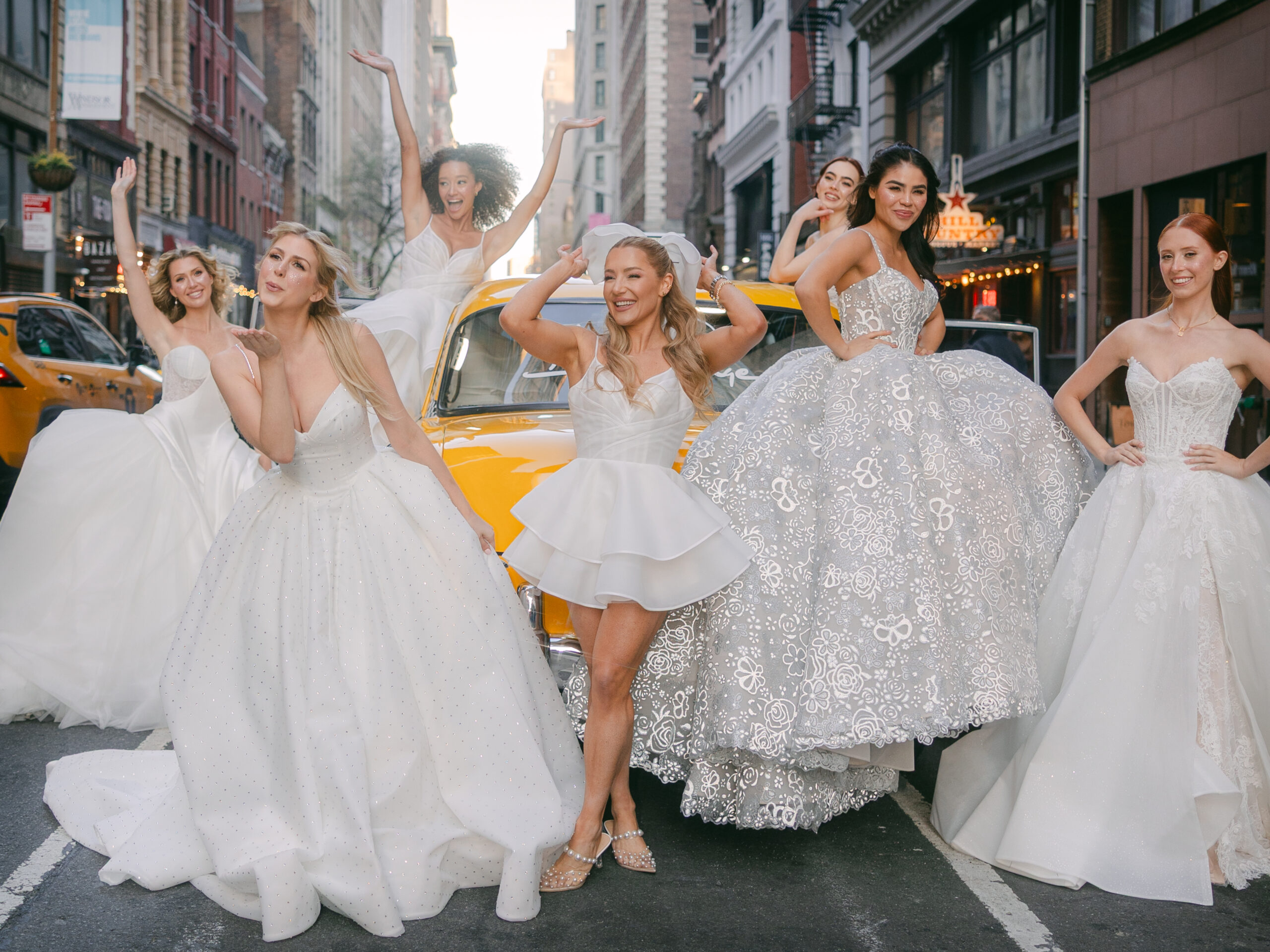 Hayley Paige and models in NYC in front of a vintage taxi